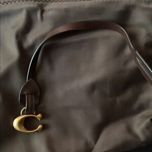 Coach C bagtag with brown leather strap